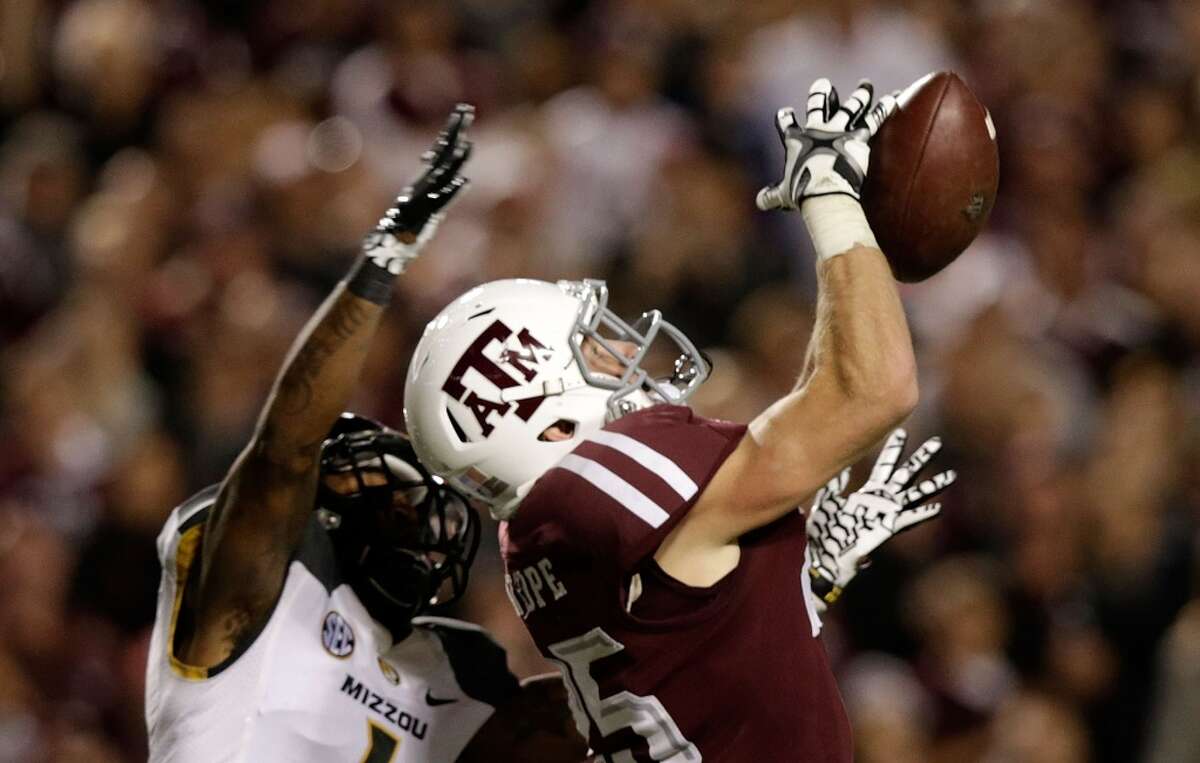 Ryan Swope #25 of Texas A&M Aggies jumps for a ball in front of Kip Edwards #1 of the Missouri Tigers at Kyle Field on November 24, 2012 in College Station, Texas. (Scott Halleran / Getty Images)
