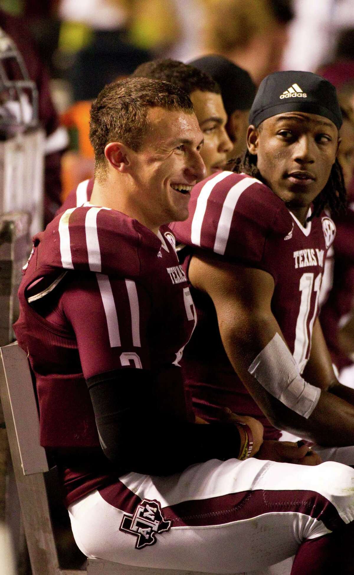 Texas A&M quarterback Johnny Manziel (2) talks to teammates on the bench during the second quarter of a NCAA football game against Missouri, Saturday, Nov. 24, 2012, in Kyle Field in College Station.