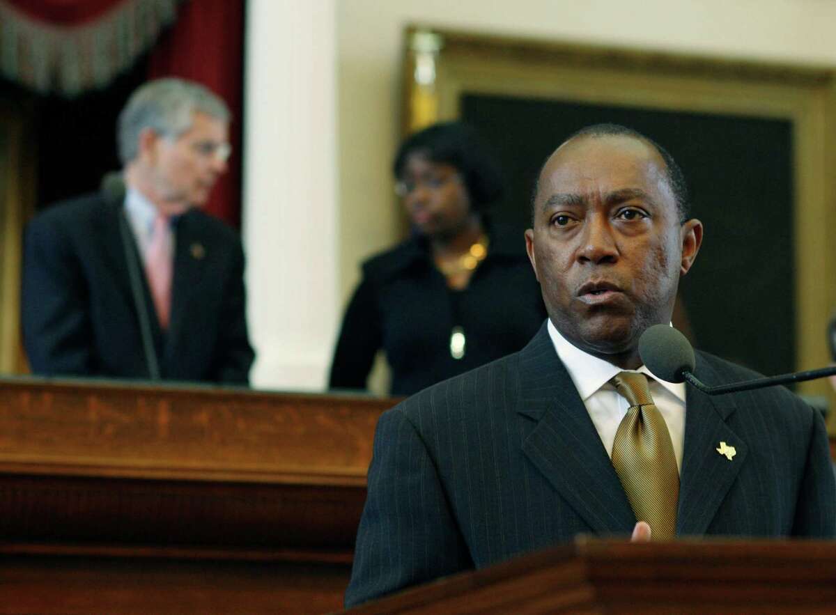 Rep. Sylvester Turner, D-Houston, foreground, speaks in behalf of his legislation during the session in the Texas House of Representatives Monday, April 2, 2007, in Austin, Texas. Turner wants to restore a fund to help low-income residents with discounts of 10 percent to 20 percent on utility bills. House Speaker Tom Craddick, R-Midland, left, talks with Parliamentarian Denise Davis in the background.