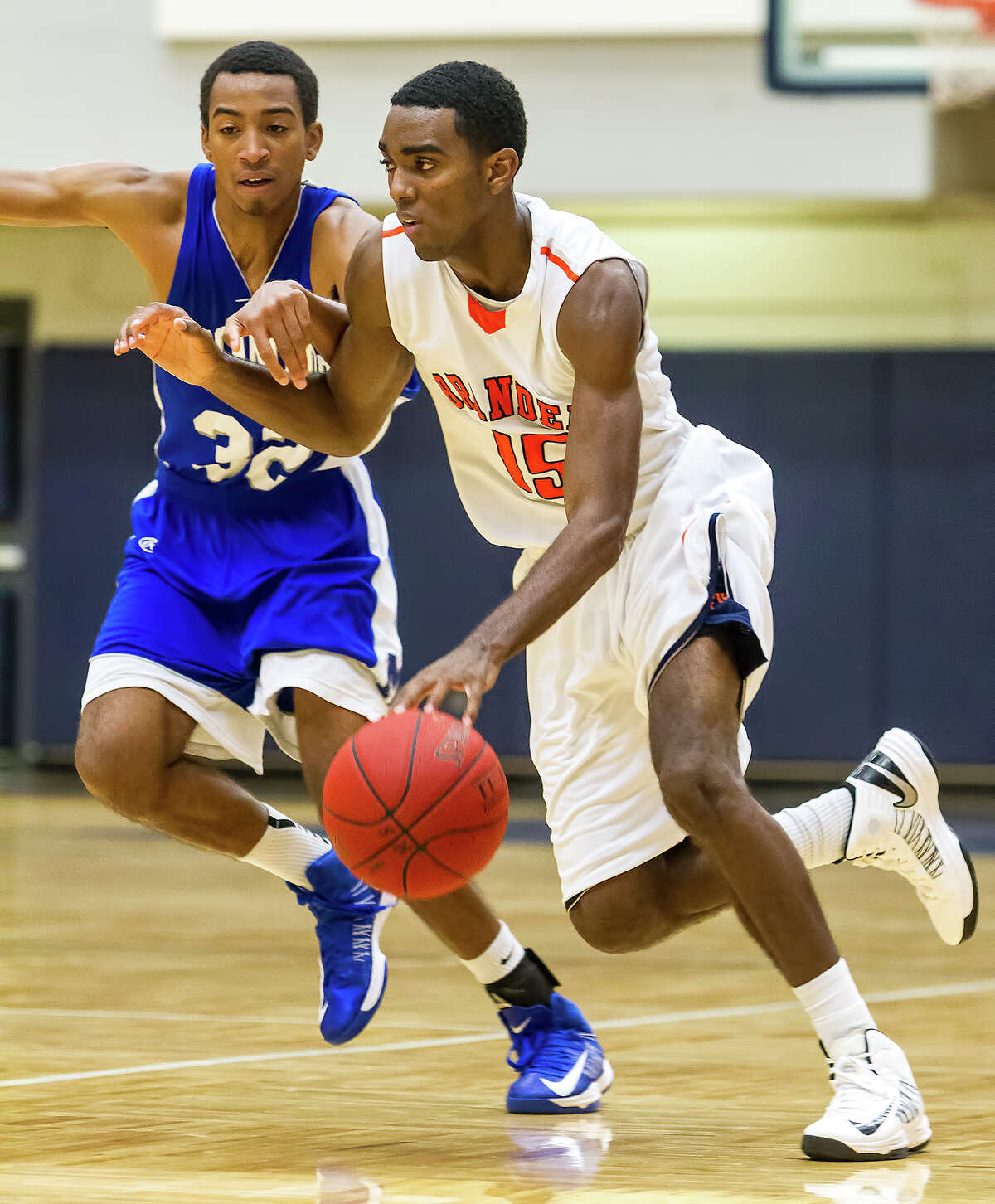 Brandeis' Justin Graham (right) drives to the basket during against MacArthur at Paul Taylor Field House on Nov. 21, 2012. Photo by Marvin Pfeiffer / Prime Time Newspapers