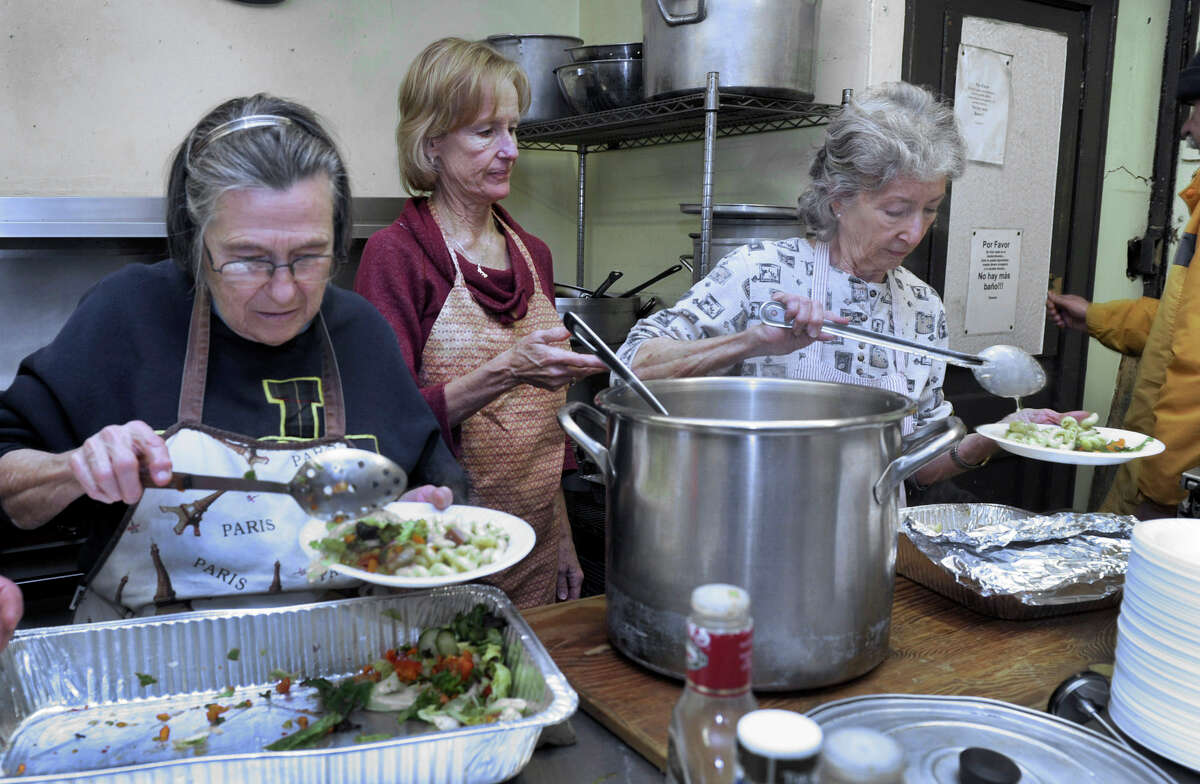 From left, Rita Crimi, Ann Maher and Betty Ballard serve the afternoon meal at the Dorothy Day Hospitality House on Spring Street in Danbury, Tuesday, Nov. 27, 2012.