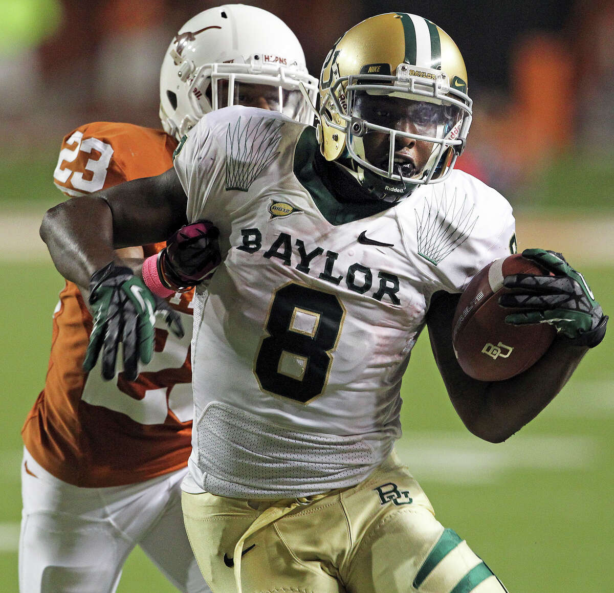 Bears running back Glasco Martin is slowed up by Carrington Byndom in the second half as Texas hosts Baylor at Darrell K Royal - Texas Memorial Stadium Stadium on Oct. 20, 2012.