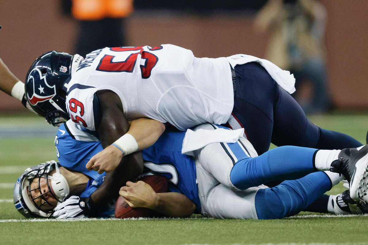 Detroit Lions quarterback Matthew Stafford (9) is tackled by Houston Texans linebacker Whitney Mercilus (59) during an NFL football game at Ford Field in Detroit, Thursday, Nov. 22, 2012. (AP Photo/Rick Osentoski)