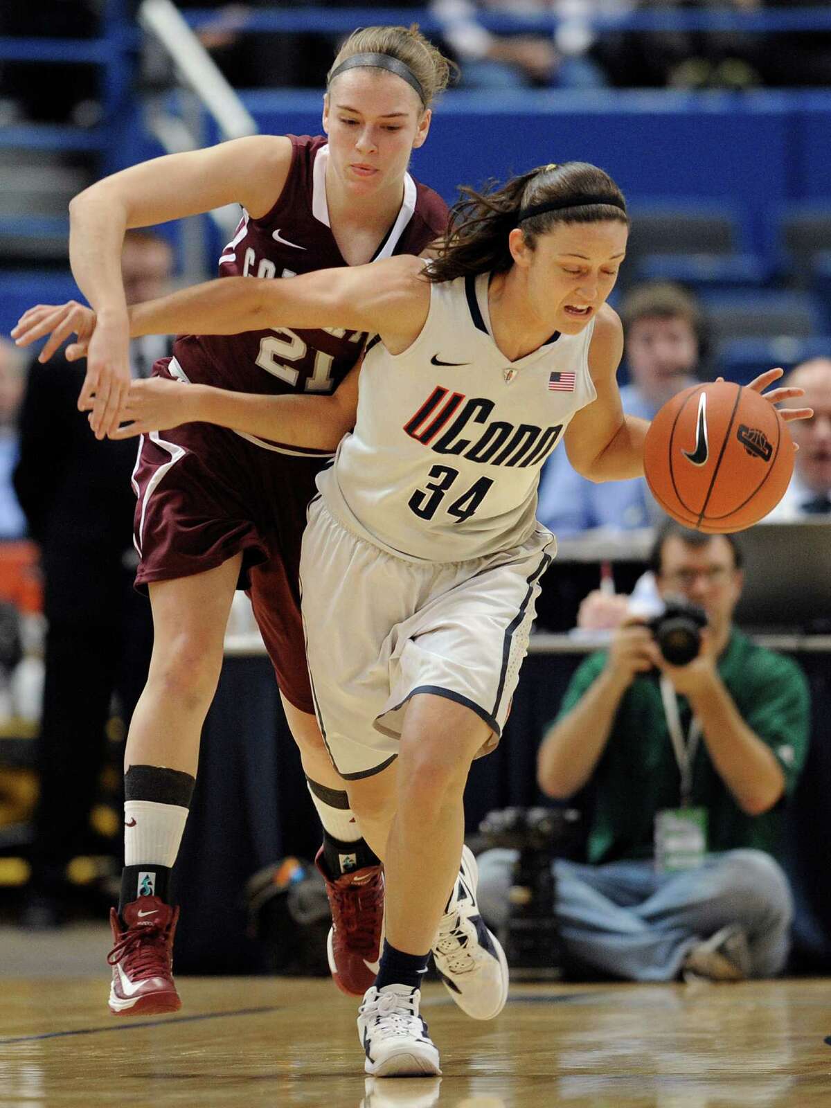 Connecticut's Kelly Faris, right, intercepts a pass intended for Colgate's Missy Repoli, left, during the first half of a NCAA college basketball game in Hartford, Conn., Wednesday, Nov. 28, 2012. (AP Photo/Jessica Hill)