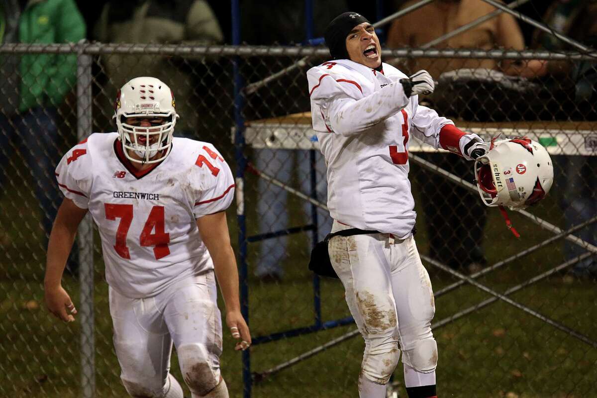 Mike Ross Connecticut Post freelance -Greenwich High School's # 3 Austin Longi celebrates after completing a 67 yard touchdown run during Wednesday evening Class LL football quarterfinals against Xavier.