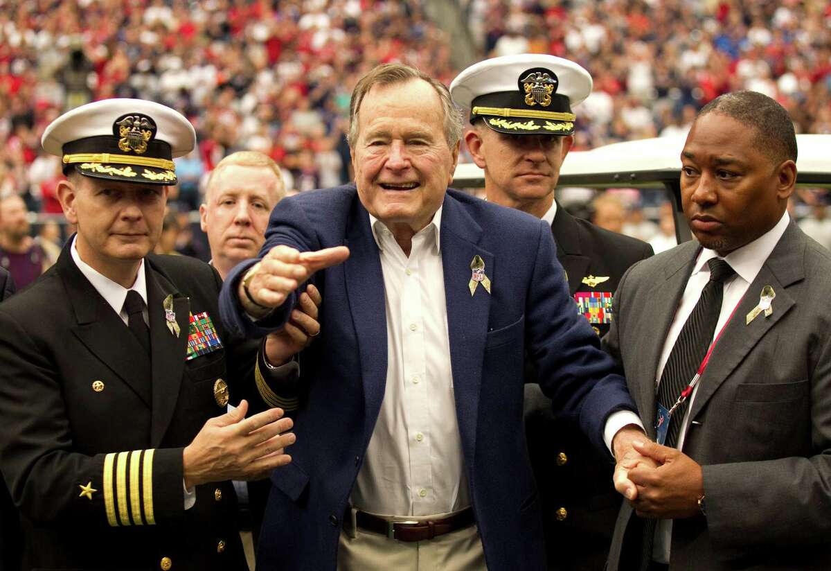 A now-ailing former President George H.W. Bush arrives for the coin toss before the Texans' game against the Buffalo Bills on Nov. 4.