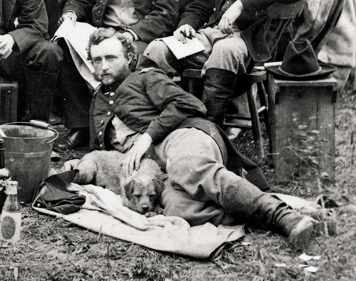 FILE - This May 20, 1862, file photograph from the Library of Congress shows a young Lt. George A. Custer reclining with a dog for a portrait with fellow staff members of General Fitz-John Porter, during the Civil War in Virginia. Years before leading his vastly outnumbered troops to their doom at Little Bighorn, a young George Armstrong Custer was described as accurate in math. This is just one tidbit gleaned from more than 115,000 U.S. Military Academy application documents being posted online for the first time by Ancestry.com. (AP Photo/Library of Congress, James F. Gibson, File)