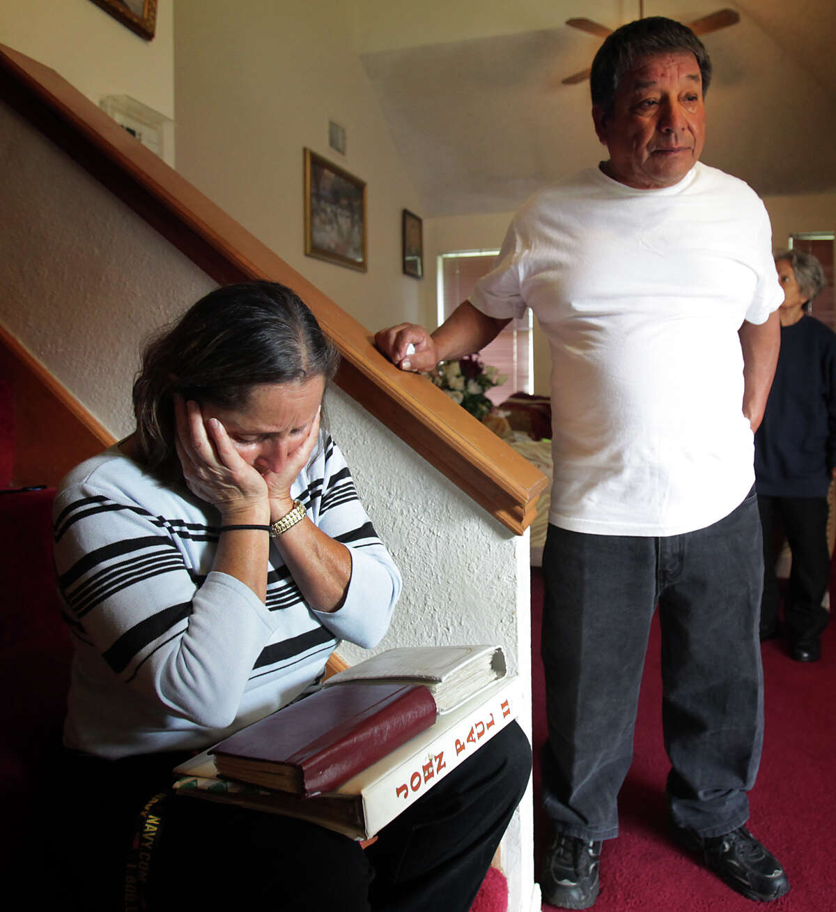 Maria Beltran, left, grieves for her son Jose Beltran, 31, and her grandson Eli Beltran, 3, who were killed after they were hit by a car, walking along Foster Rd. near I-10. Ricardo Espinoza, Jose's step father, is at right. Friday, Nov. 30, 2012.