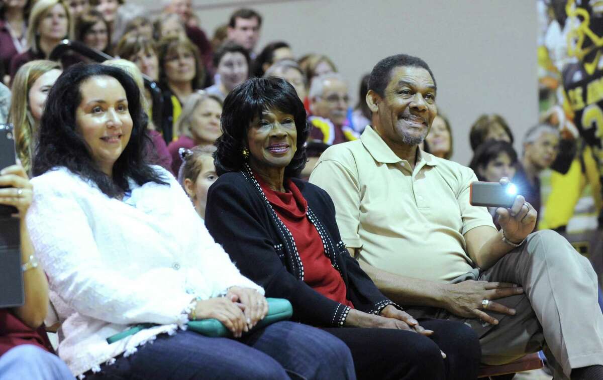 Valerie Robinson, left, mother of Corey Robinson, and Corey's grandparents, Freda and Ambrose Robinson, watch him speak during a ceremony to announce his selection to the U.S. Army All-American Bowl at San Antonio Christian High School on Friday, Nov. 30, 2012. Corey is the son of NBA legend David Robinson.