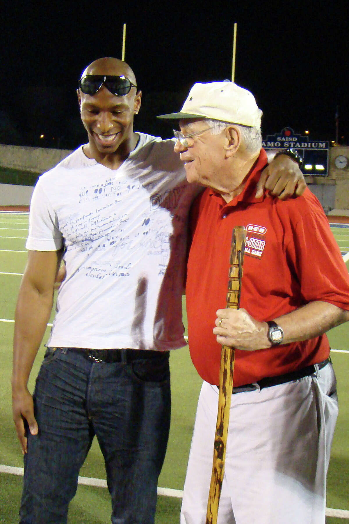 Dallas Cowboys wide receiver Sam Hurd embraces coach George Pasterchick at 2010 H-E-B San Antonio High School All-Star Football Game on May 17, 2010. Hurd played for Pasterchick in this game in 2002.