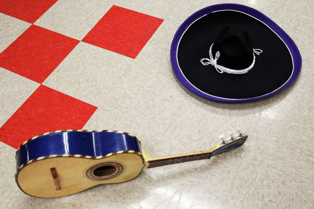 A vuhuela and sombrero wait on the floor in the dressing room while Mariachi Pantera from Jefferson Davis High School in Houston prepare for their performance in the Group Competition during the 18th annual Mariachi Vargas Extravaganza at Lila Cockrell Theatre, Friday, November 30, 2012.