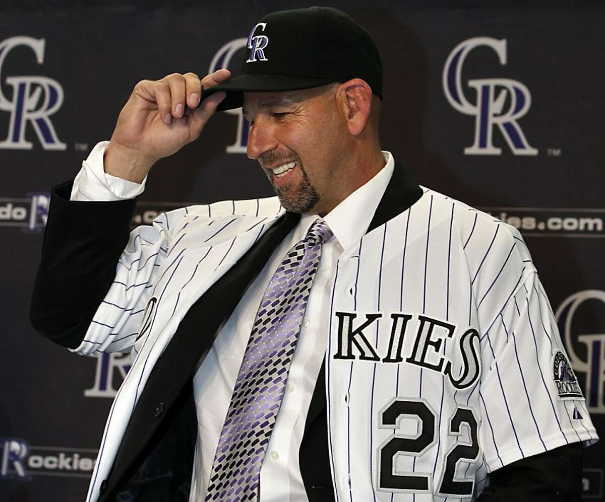 Walt Weiss smiles as he puts on a Colorado Rockies baseball cap during a news conference where he was introduced as the team's new manager in Denver, Friday, Nov. 9, 2012. The former major league shortstop replaces former manager Jim Tracy, who resigned on Oct. 7. (AP Photo/Brennan Linsley)