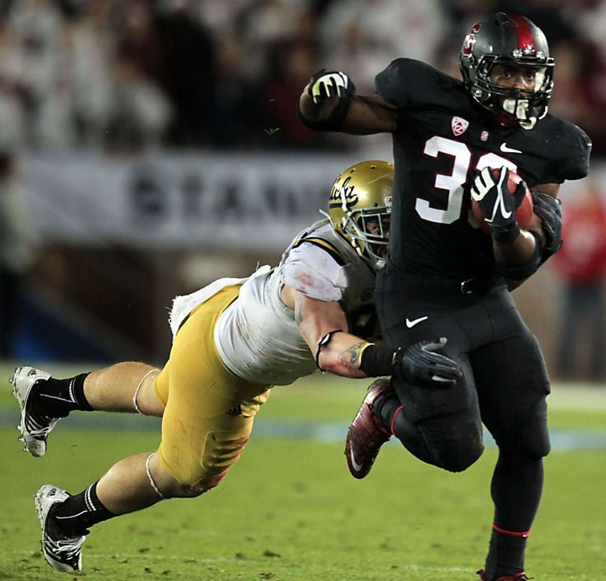 Stanford Stepfan Taylor escapes a tackle for a 33 yard gain in the first quarter Friday Nov. 30, 2012, in the Pack 12 championship game with UCLA in Stanford, Calif.