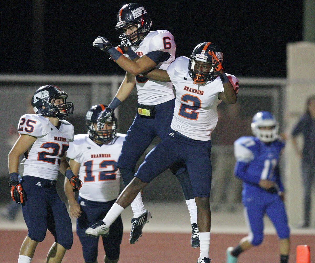 Brandeis' Trevor Hernandez (from left) watches as teammates Brandeis' Alec Sifuentes and Brandeis' Kadarius Lee celebrate after Lee scored a touchdown on a punt return against Del Rio during first half action Friday Nov. 30, 2012 at Eagle Pass ISD Stadium in Eagle Pass, Tx