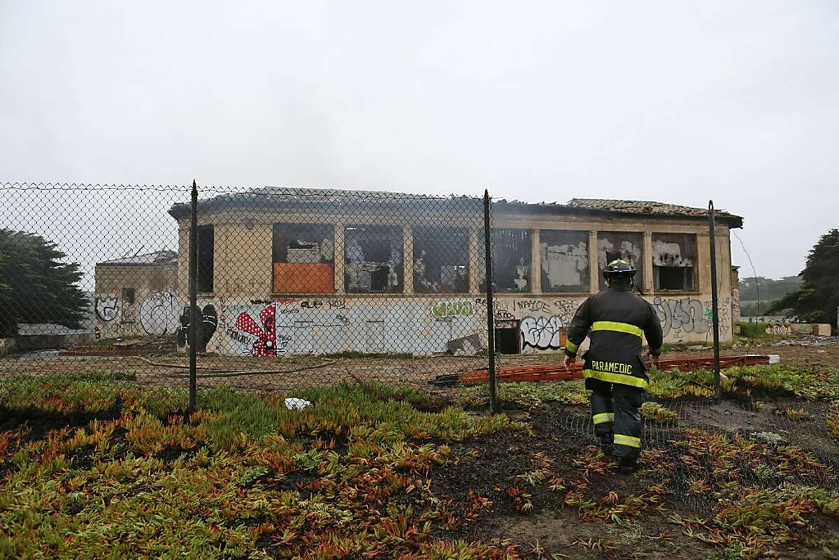 A firefighter collects gear used outside of the historic Fleishhacker Pool at the San Francisco Zoo on December 1, 2012.