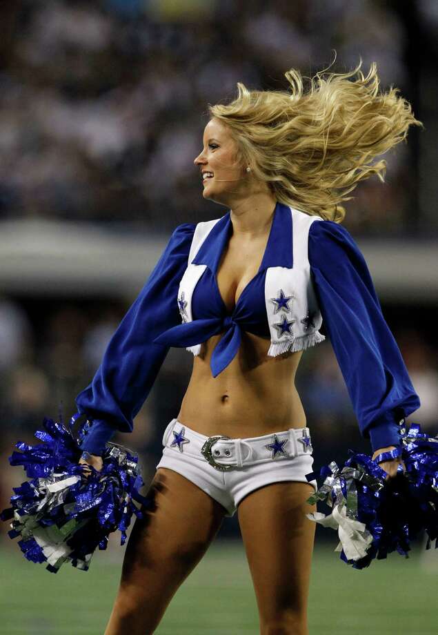 A member of the Dallas Cowboys cheerleaders performs during an NFL football...