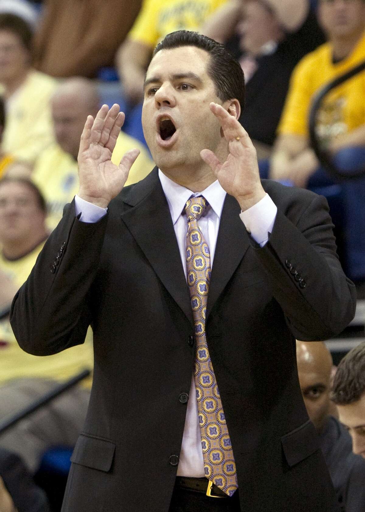 Quinnipiac head coach Tom Moore yells at his team during the first half of the NCAA Northeast Conference college championship basketball game against Robert Morris in Hamden, Conn., Wednesday, March 10, 2010. (AP Photo/Thomas Cain)