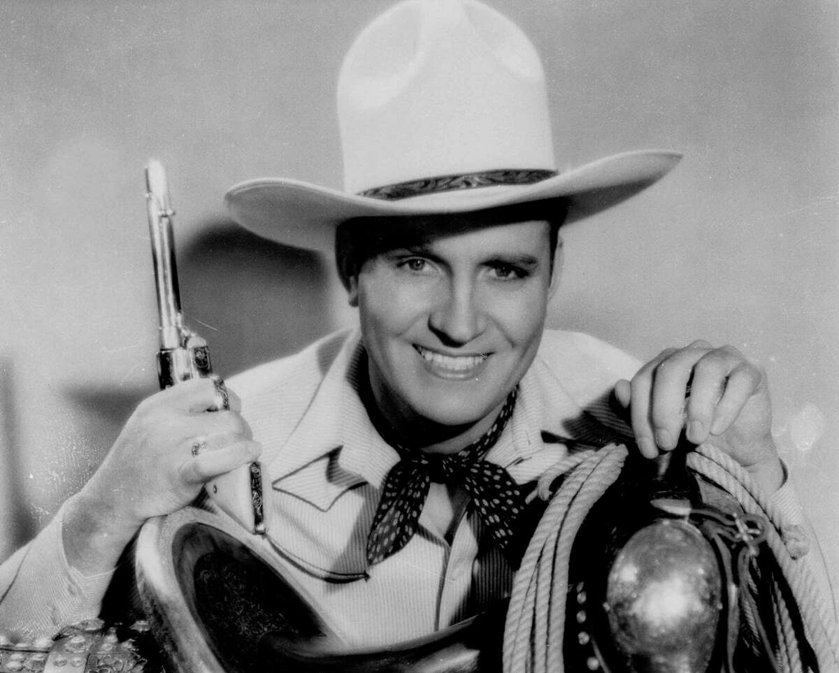 Top: The H-E-B Christmas commercial features towns with Christmassy names. Above: Singing cowboy star Gene Autry.﻿