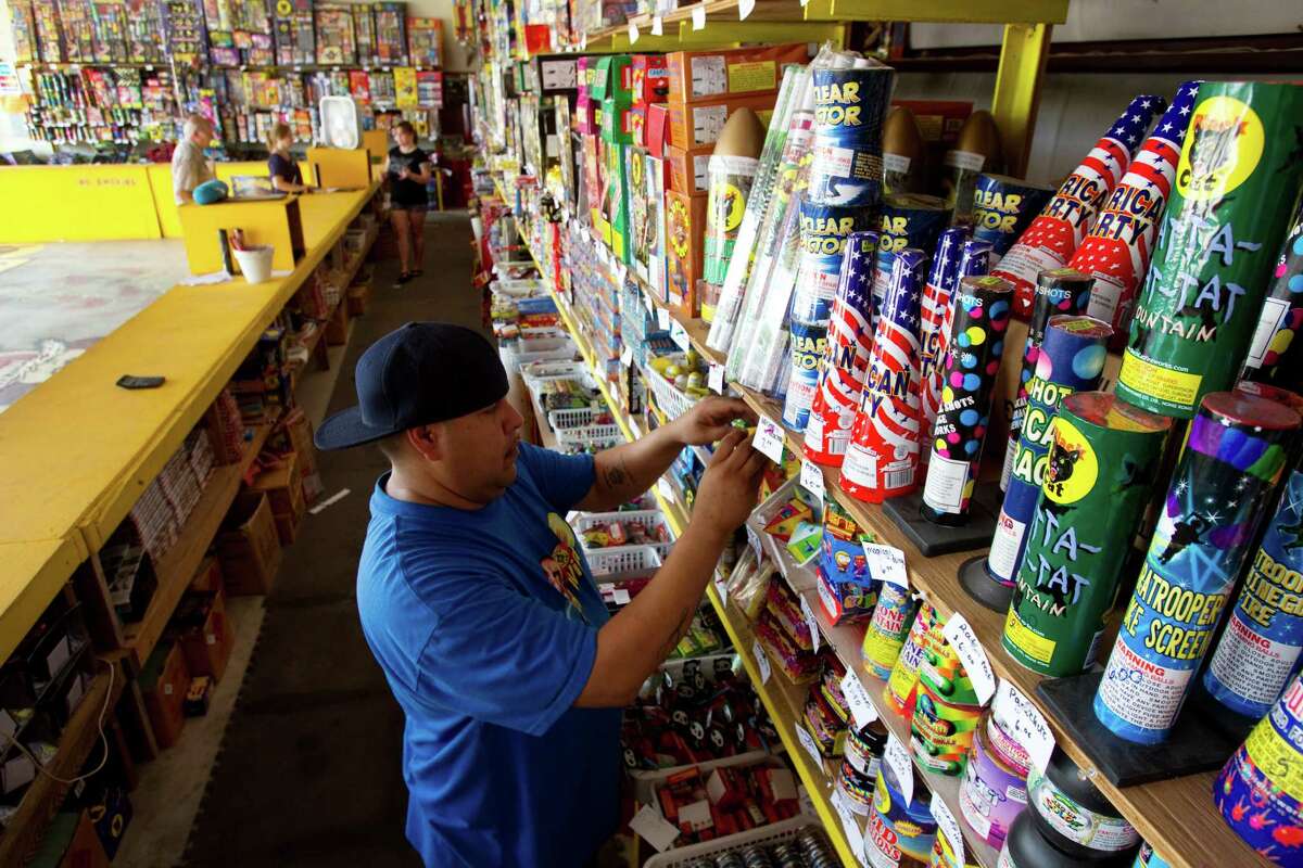 Lou Rodriguez stocks the shelves at Mrs. Becky's Firework Warehouse Wednesday, June 29, 2011, in Dickinson. If a state lawmaker has his way, fireworks could be sold more frequently in Texas. 