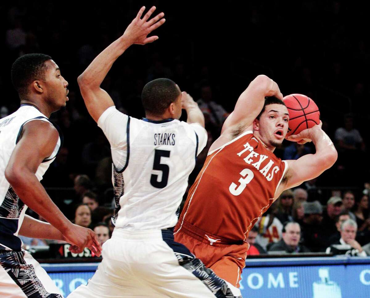 Texas' Javan Felix (3) looks to pass away from Georgetown's Markel Starks (5) during the second half of their NCAA college basketball game in the Jimmy V Classic at Madison Square Garden, Tuesday, Dec. 4, 2012, in New York. Georgetown won 64-41.