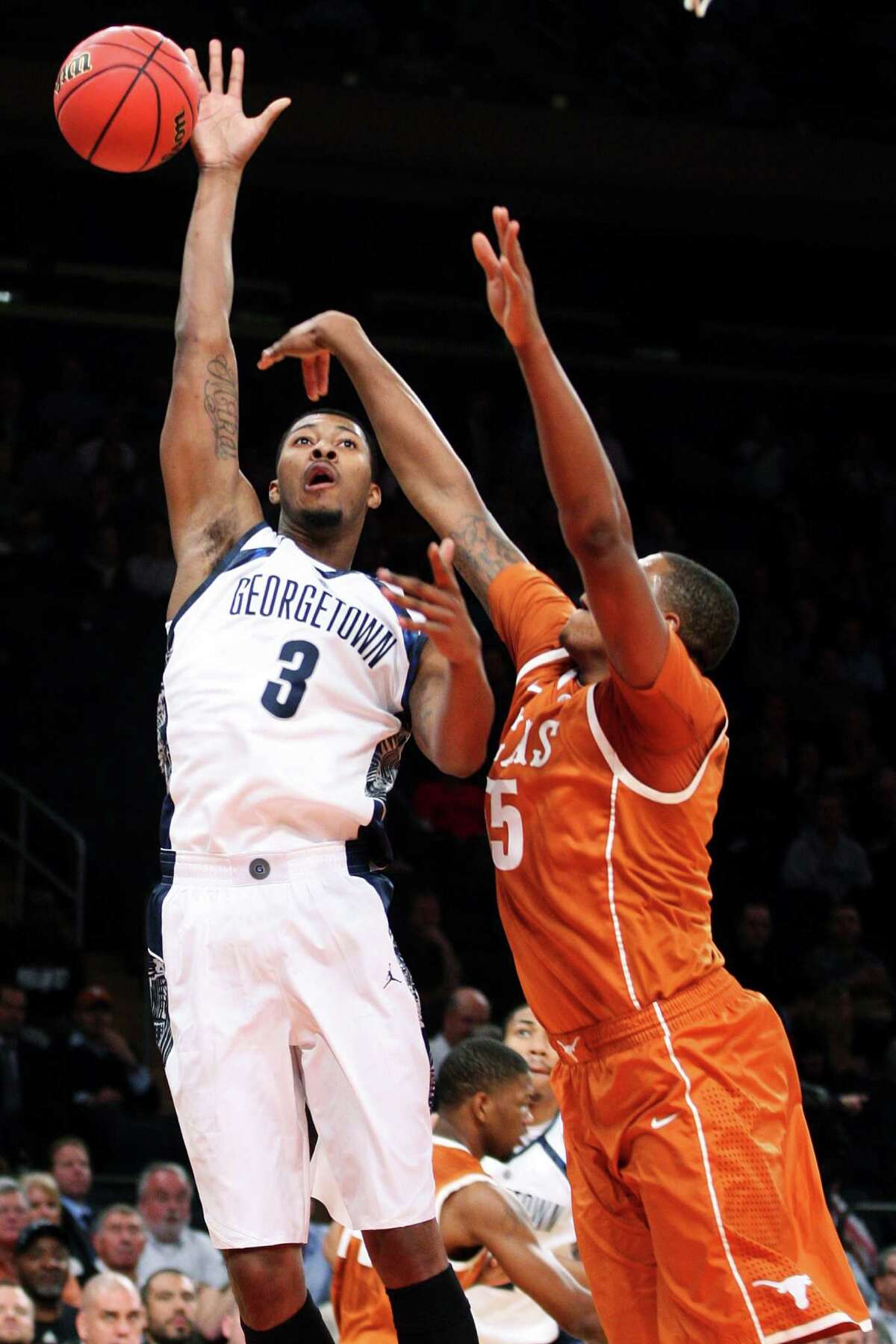 Georgetown's Mikael Hopkins (3) shoots over Texas' Cameron Ridley (55) during the first half of their NCAA college basketball game in the Jimmy V Classic, Tuesday, Dec. 4, 2012, at Madison Square Garden in New York. (AP Photo/Frank Franklin II)