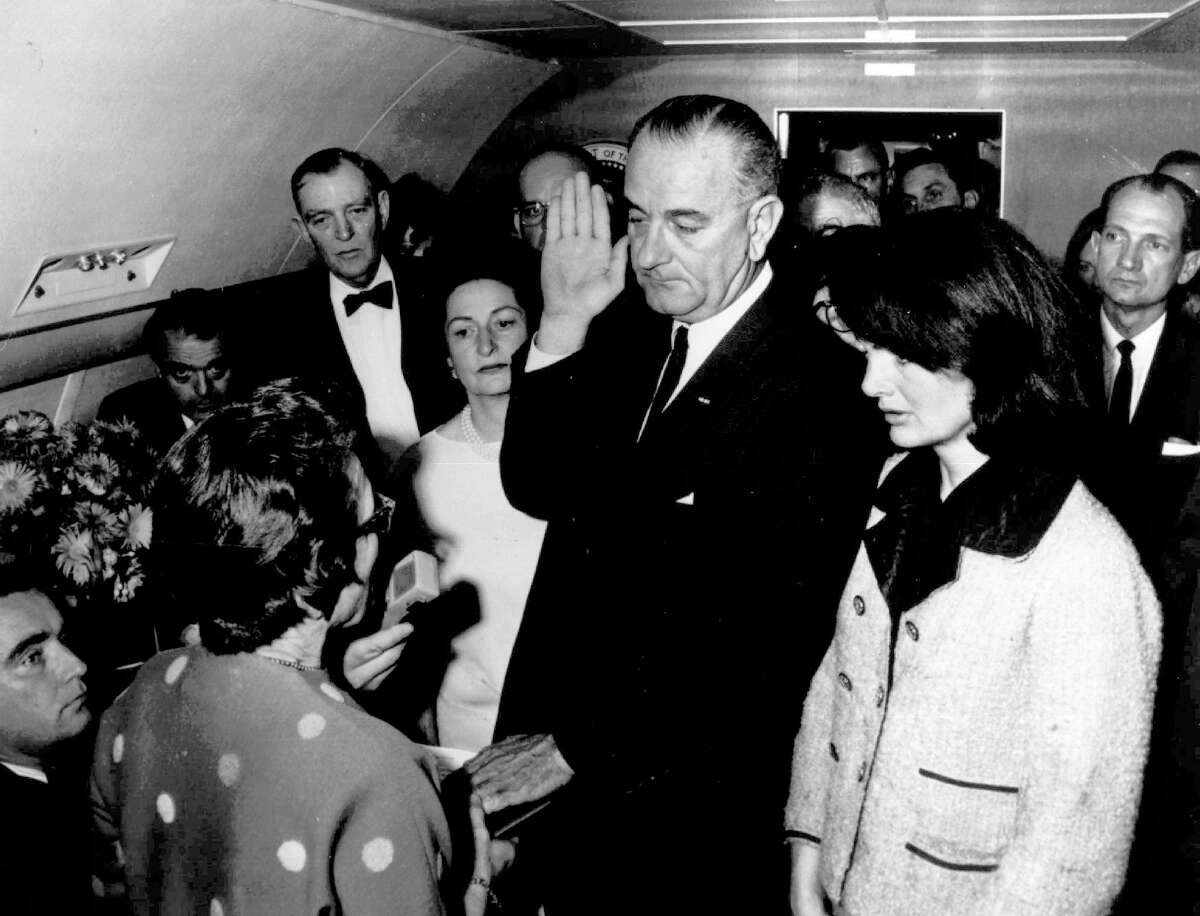 **FILE** Lyndon B. Johnson is sworn in as President of the United States of America in the cabin of the presidential plane as Mrs. Jacqueline Kennedy stands at his side in this Nov. 22, 1963 file photo. Judge Sarah T. Hughes, a Kennedy appointee to the Federal court, left, administers the oath. In background, from left are, Jack Valenti, administrative assistant to Johnson; Rep. Albert Thomas, D-Tex.; Lady Bird Johnson; and Rep. Jack Brooks, D-Tex. Lady Bird Johnson, the former first lady who championed conservation and worked tenaciously for the political career of her husband, former President Lyndon B. Johnson, died Wednesday, a family spokeswoman said. She was 94.