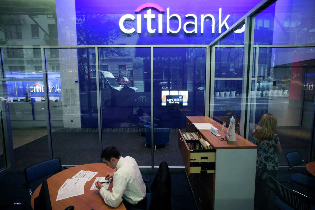 FILE - This Oct. 13, 2011 file photo, shows a Citibank branch in New York. Citigroup said Wednesday, Dec. 5, 2012, that it will cut 11,000 jobs, a bold early move by new CEO Michael Corbat. The cuts amount to about 4 percent of Citi?s workforce of 262,000. The bulk of the cuts, about 6,200, will come from Citi?s consumer banking unit, which handles everyday functions like branches and checking accounts. (AP Photo/Mark Lennihan, File)