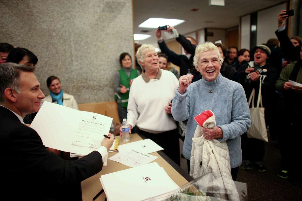Jane Abbott Lightly and her partner Pete-e Petersen, right, celebrate as King County Executive Dow Constantine signs their marriage license at the King County Administration Building on shortly after midnight on Thursday, December 6, 2012.