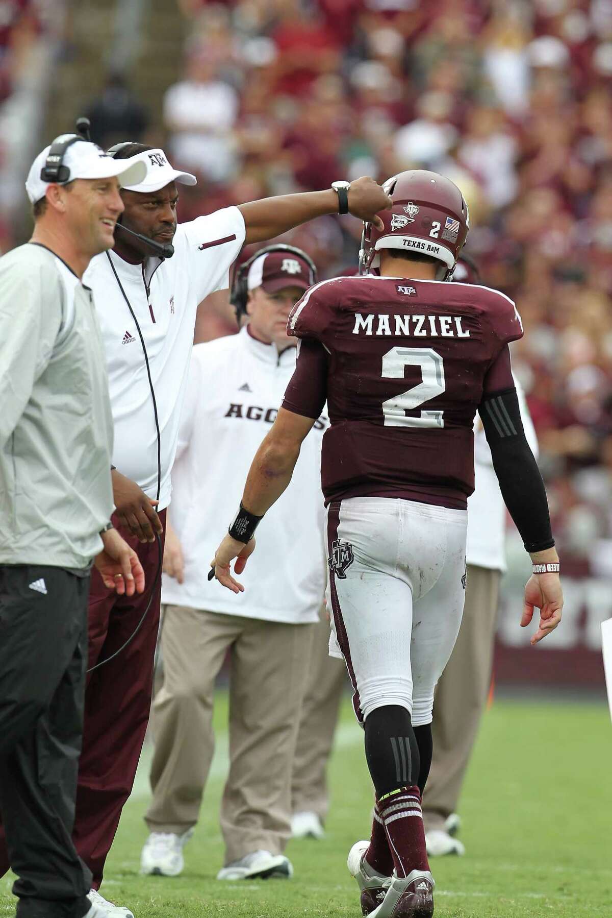 Texas A&M quarterback Johnny Manziel (2) celebrates his touchdown Texas A&M head coach Kevin Sumlin in the fourth quarter of a college football game at Kyle Field, Saturday, Sept. 29, 2012, in College Station. Texas A&M beat Arkansas 58-10.
