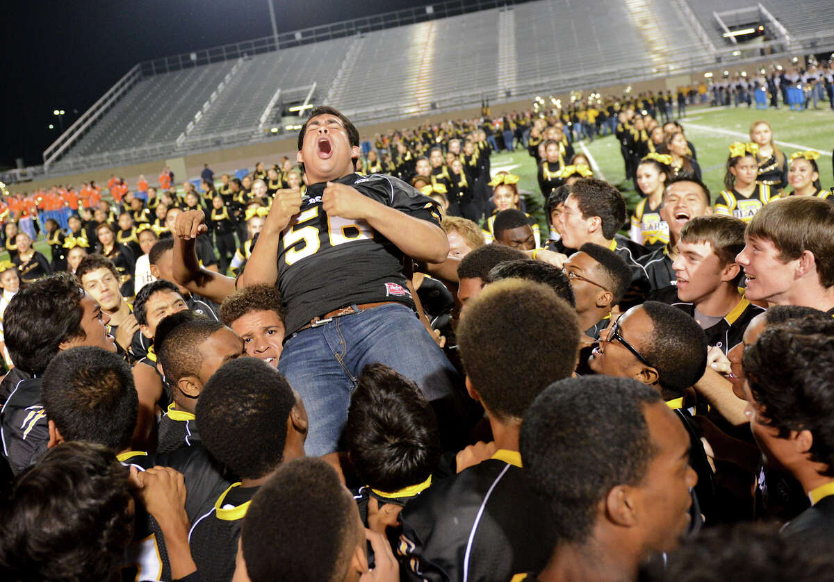 Brennan's Julio Compean is lifted up by his teammates as the Bears celebrate on the field at the end of a NISD three school football playoff pep rally for Brandeis, Brennan and O'Connor at Farris Stadium in San Antonio, Thursday, December 6, 2012. John Albright / Special to the Express-News.