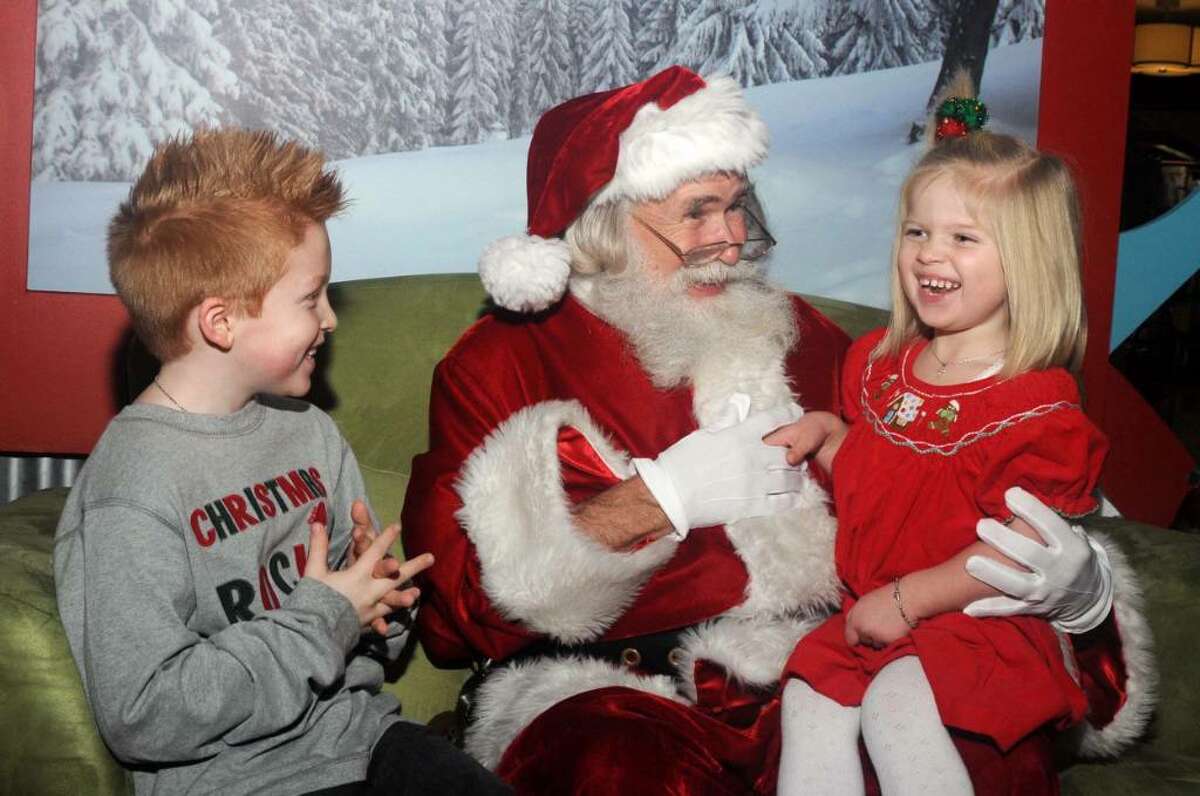 Deven Webb, 7, on the left and his sister Rylee, 3, of Danbury enjoy a visit to Santa Claus at the Danbury Fair Mall on Thursday Dec. 3, 2009.