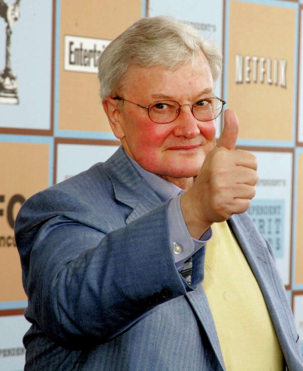 Film critic Roger Ebert gives a thumbs-up sign as he arrives at the Independent Spirit Awards in Santa Monica, California, in this March 4, 2006 file photo. Ebert announced July 21, 2008 that he and Richard Roeper are departing the movie review show that bears their names, leaving the future of the influential program unclear. REUTERS/Fred Prouser/Files (UNITED STATES)