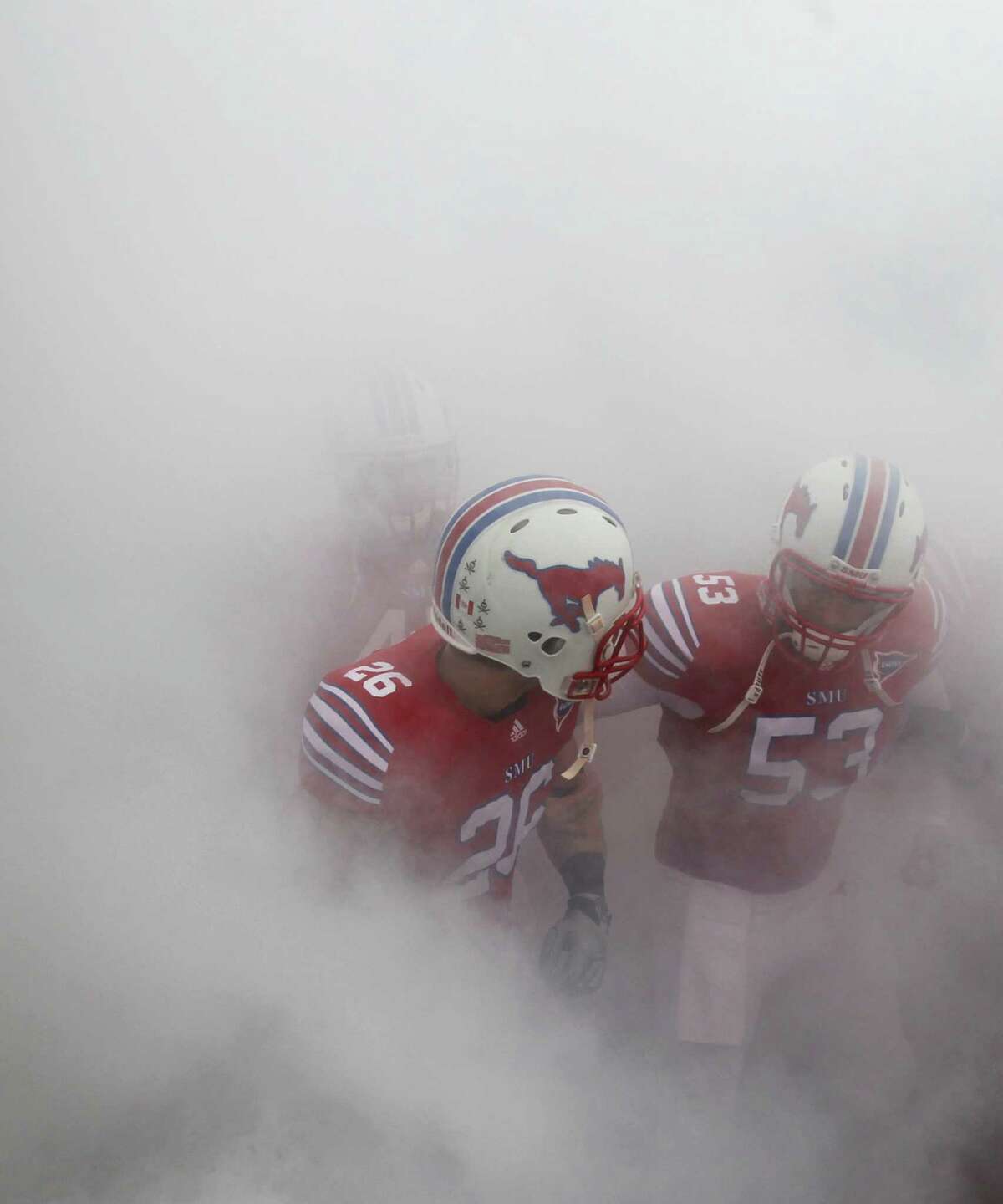 Hawaii Bowl, Dec. 24, SMU vs. Fresno State: SMU senior deep snapper Mark Voosen (53) is from New Braunfels Canyon.Caption: MU DB Brett Haness (26) and DS Mark Voosen (53) wait in the smoke to take the field before the SMU Mustangs vs. the Rice Owls college football game at Gerald J. Ford Stadium in Dallas on Saturday, November 26, 2011. (Louis DeLuca/The Dallas Morning News)