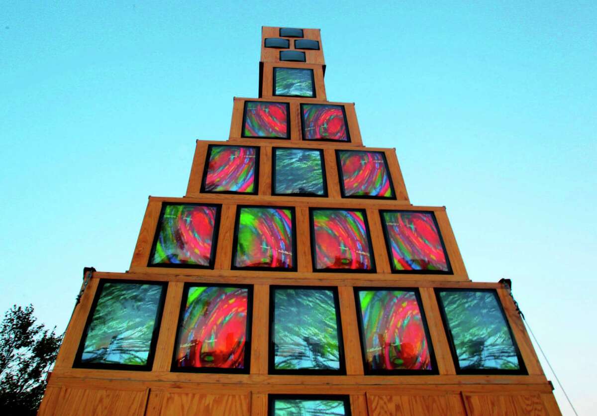 Andy Mann's Christmas Tree,The most moving Christmas decoration in Houston? For my money, it's a revival of one that used to be the most avant-garde: Video artist Andy Mann's 1989 Christmas tree made of televisions, their fat old CRT screens abuzz in abstract patterns. The revived Tree is at Discovery Green, by Kinder Lake. (Billy Smith II / Houston Chronicle