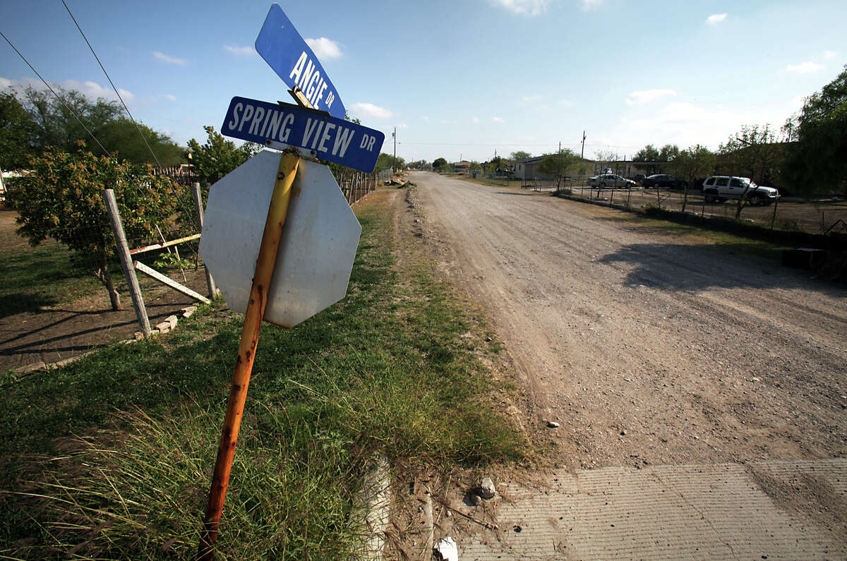 The intersection of Angie and Spring View drives in the Pueblo Nuevo colonia just outside of Eagle Pass may be made of concrete, but many of the streets in the area remain unpaved.