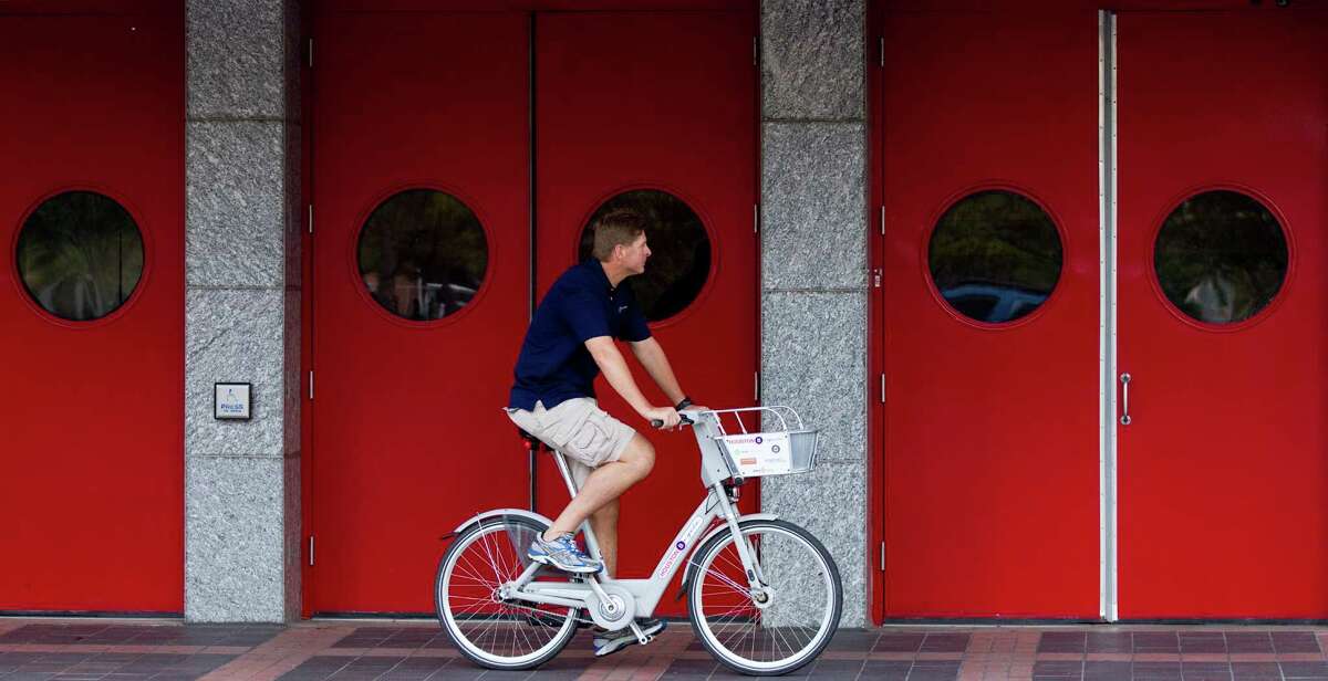 Will Rub, director Houston Bike Share, cruises Friday in front of the George R. Brown Convention Center on a bicycle rented from one of three downtown kiosks.