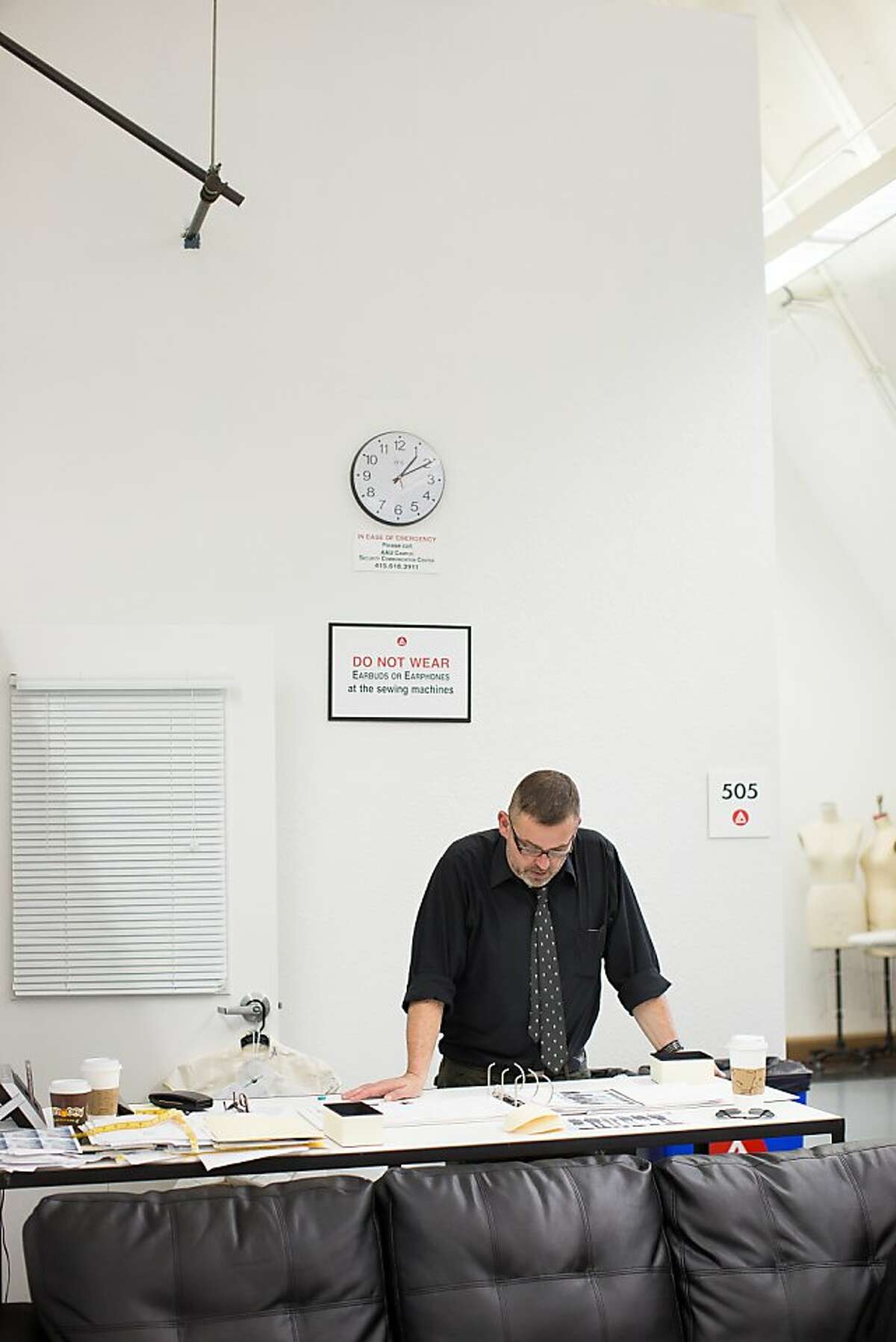Simon Ungless, Director of the School of Fashion at the Academy of Art University, looks over student designs on Friday, Nov. 16, 2012 in San Francisco, Calif.