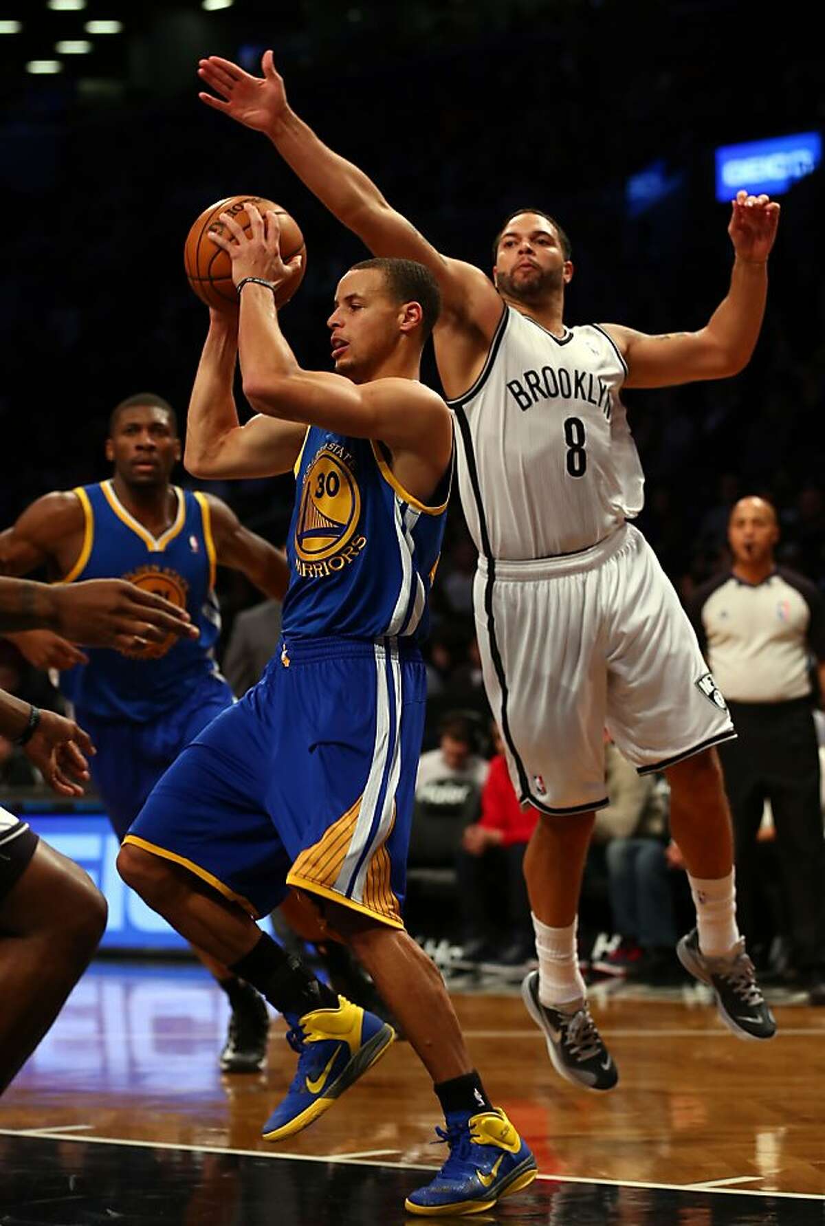 NEW YORK, NY - DECEMBER 07: Stephen Curry #30 of the Golden State Warriors tries to pass as Deron Williams #8 of the Brooklyn Nets defends on December 7, 2012 at the Barclays Center in the Brooklyn borough of New York City. NOTE TO USER: User expressly acknowledges and agrees that, by downloading and/or using this photograph, user is consenting to the terms and conditions of the Getty Images License Agreement. (Photo by Elsa/Getty Images)