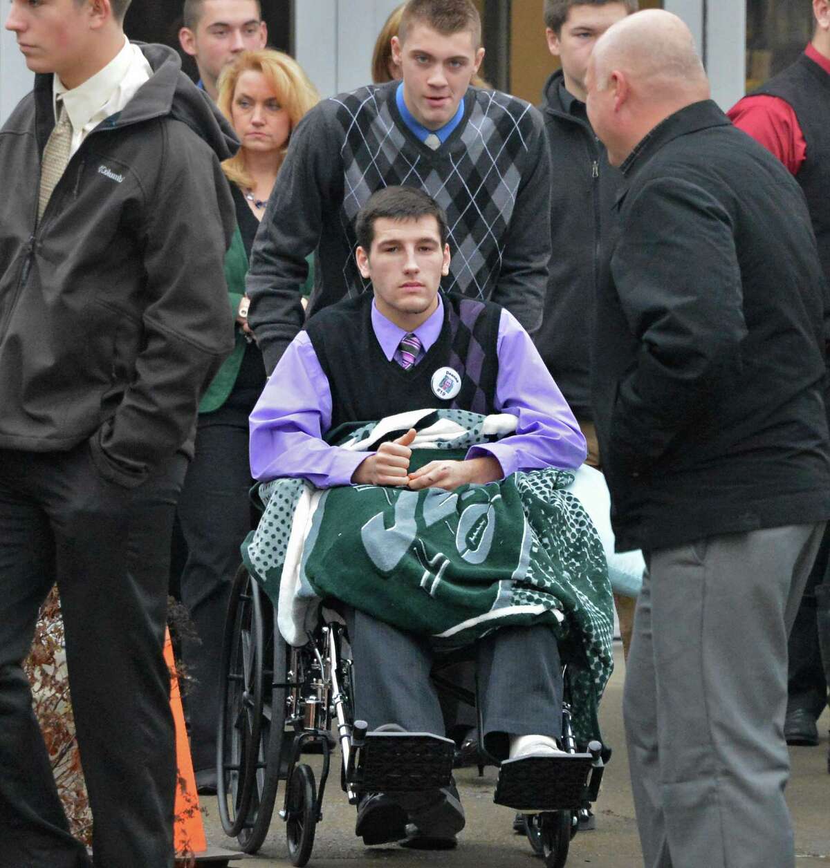 Shen student Matt Hardy center, leaves Corpus Christi Church in Round Lake Saturday Dec. 8, 2012, following funeral services for Chris Stewart, the 17-year-old Shenendehowa student who died along with classmate Deanna Rivers in a crash on the Northway that left two other teens injured. Hardy was one of the teens seriously injured in the crash. (John Carl D'Annibale / Times Union)