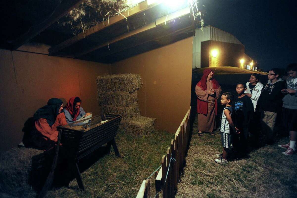Aubrey Rodriguez as Mary and Brady Moore as Joseph hold a doll representing the Christ child during a living replica of Bethlehem called "Christmas City" at Gateway Church, 6623 Five Palms Dr., on Thursday, Dec. 6, 2012. The event continues nightly through Sunday.