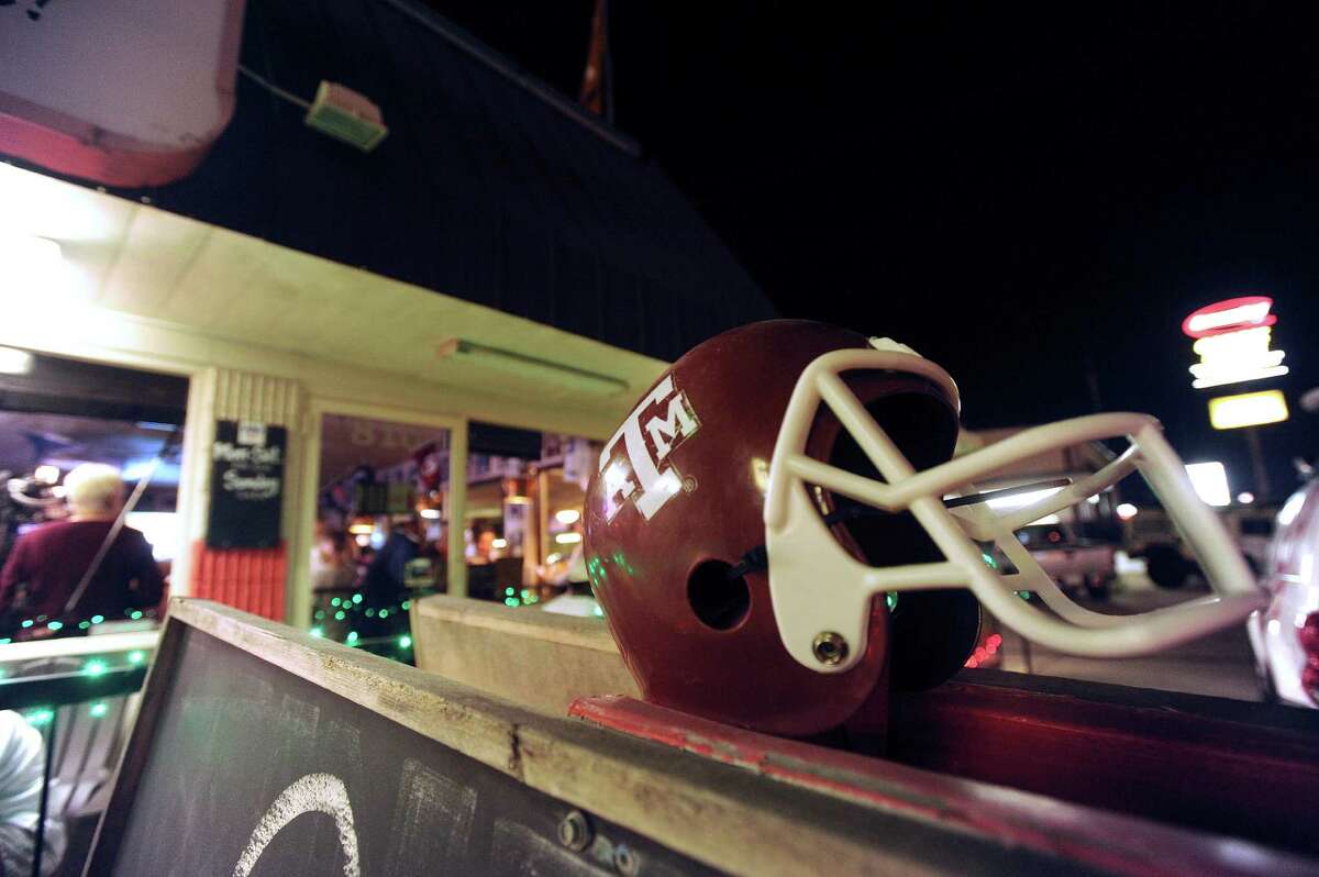 A Texas A&M helmet adorns the Wing King restaurant in Kerrville, Texas, where fans gathered for a Heisman Trophy announcement watch party on Saturday night, Dec. 8, 2012. Johnny Manziel, who played high school football for Tivy High School in Kerrville, won the Heisman trophy.