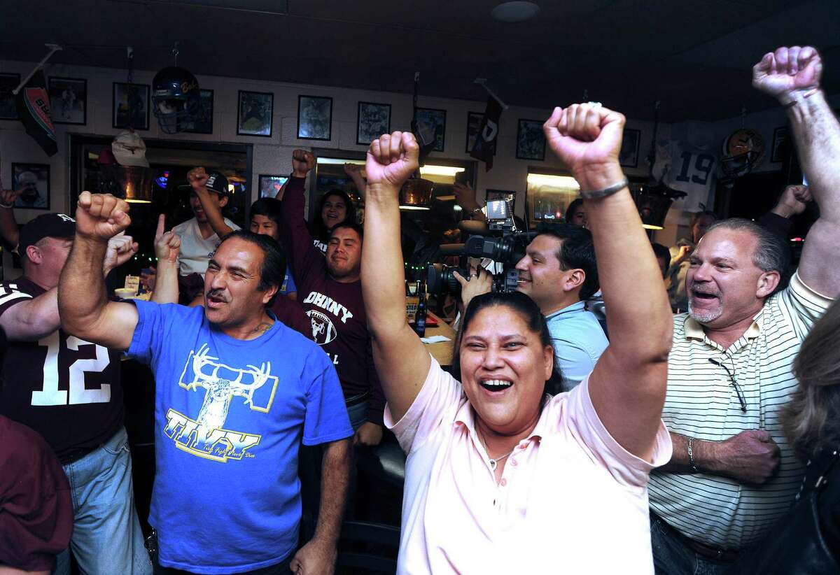 Fans of Texas A&M quarterback Johnny Manziel gather at the Wing King restaurant in Kerrville, Texas, for the televised Heisman Trophy announcement on Saturday night, Dec. 8, 2012. Manziel played high school football for Tivy High School in Kerrville.