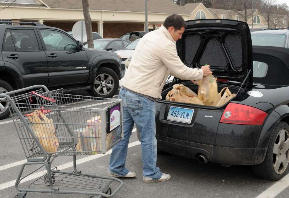 Umberto Torrielli, of Monroe, CT shopping at the Stop & Shop in Newtown, loads his car with groceries, in preparation for the big snow storm, on Saturday, Dec. 19, 2009.