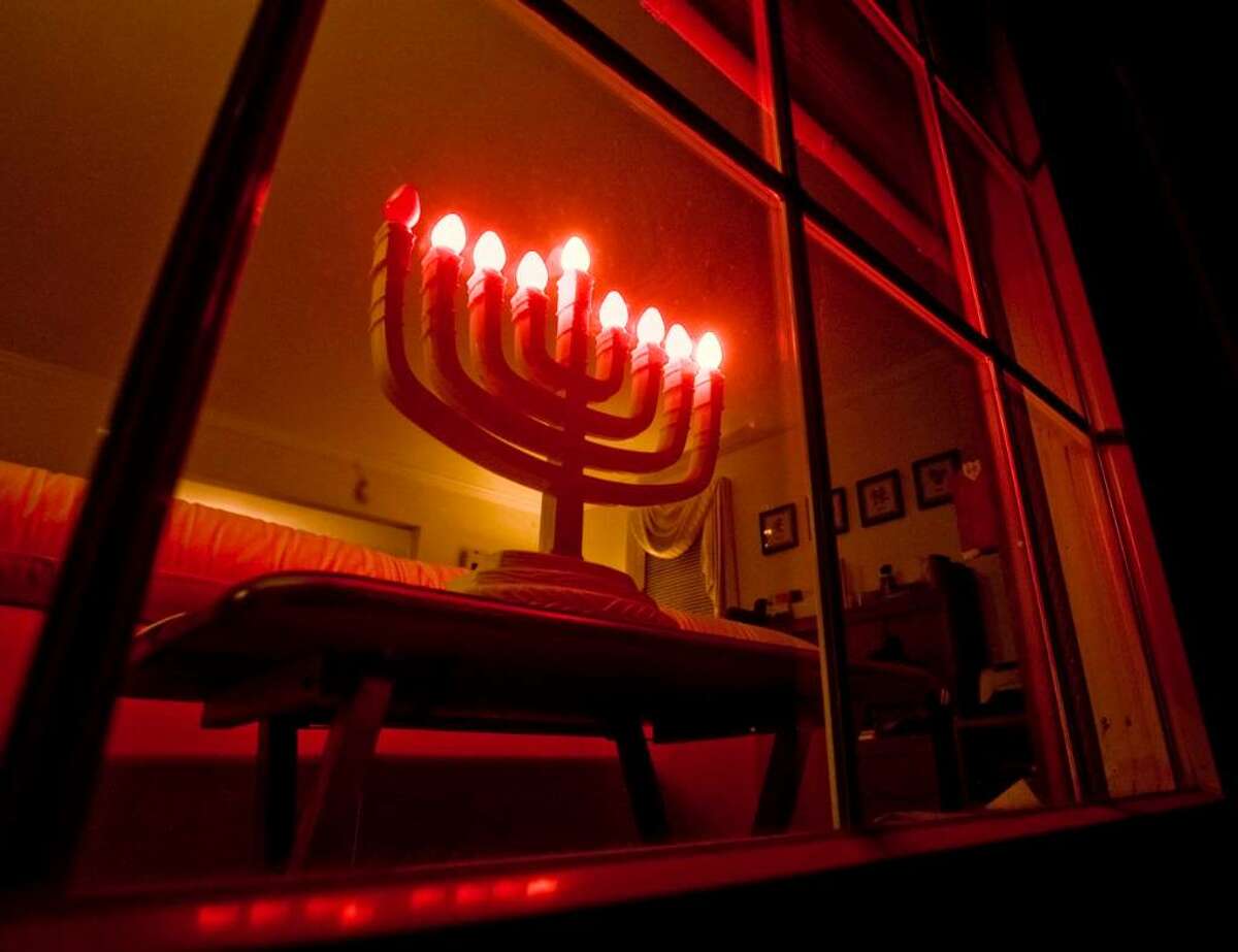 The menorah glows in the window at the Kessler home in Bethel. Thursday, Dec. 17, 2009