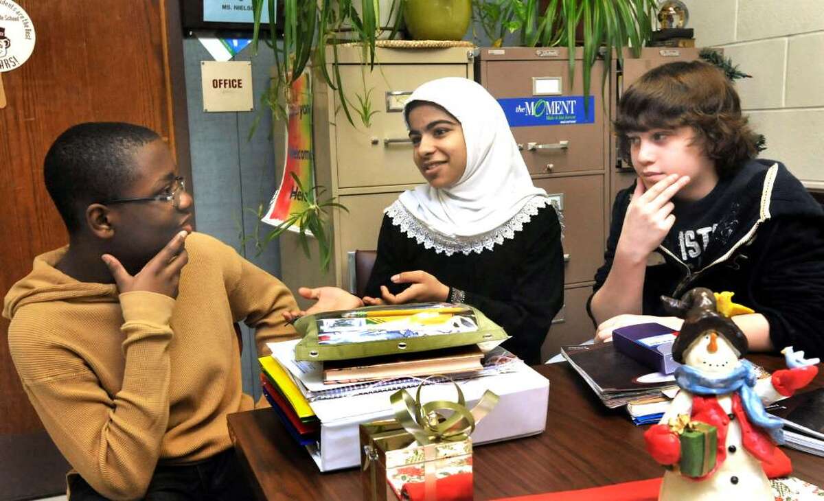 Broadview Middle School students talk about their holiday traditions, in Danbury, on Thursday, Dec.17,2009. From left are: Jordon Pierre, 13, in 8th grade, Anwar Abdulrehman, Evan Coco, both 12 and in 7th grade.