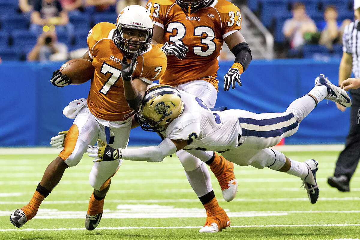 O'Comnor's Marces Garza-Dishmon (right) tries to make a flying tackle on Madison's Marquis Warford during the first quarter of their Class 5A Division I state quarterfinal game at the Alamodome on Dec. 8, 2012. Warford ran for 256 yards and five touchdowns though O'Connor beat the Mavericks 52-49. MARVIN PFEIFFER/ mpfeiffer@express-news.net