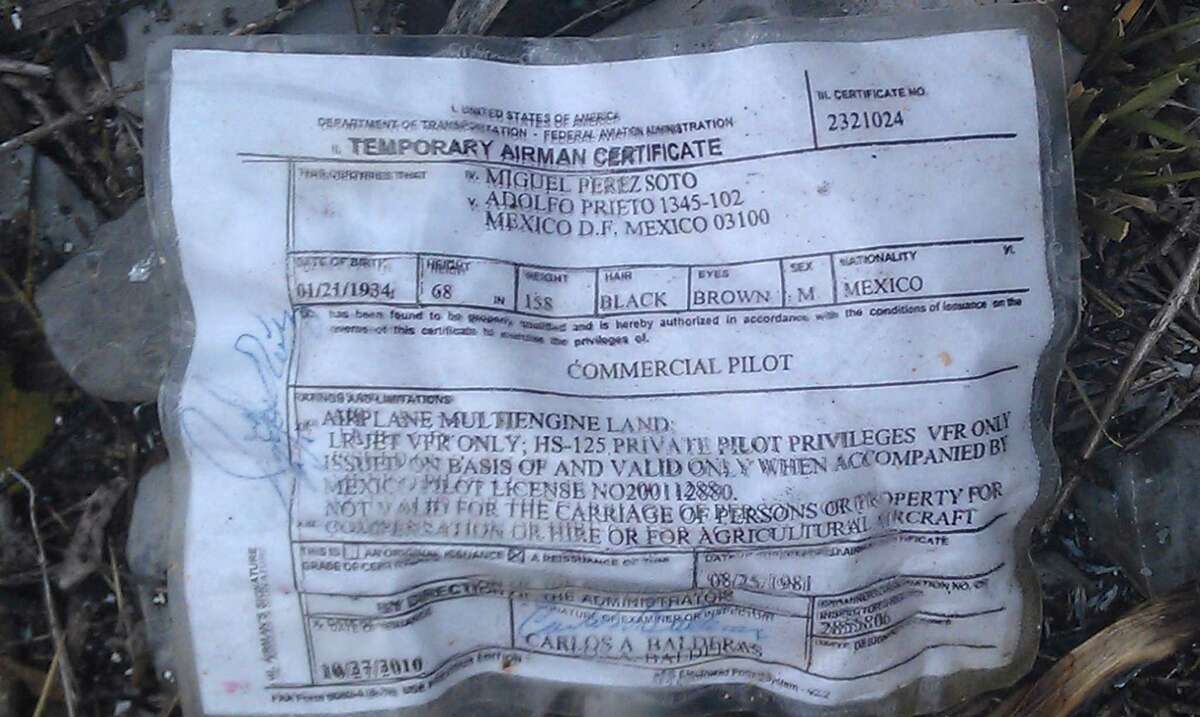 A temporary airman's certificate issued by the Federal Aviation Administration (FAA) sits on the ground at the crash site where a plane carrying U.S. born singer Jenni Rivera apparently crashed near Iturbide, Mexico Sunday Dec. 12, 2012. The wreckage of a small plane believed to be carrying Rivera, the singer whose soulful voice and unfettered discussion of a series of personal travails made her a Mexican-American superstar, was found in northern Mexico on Sunday. Authorities said there were no survivors.