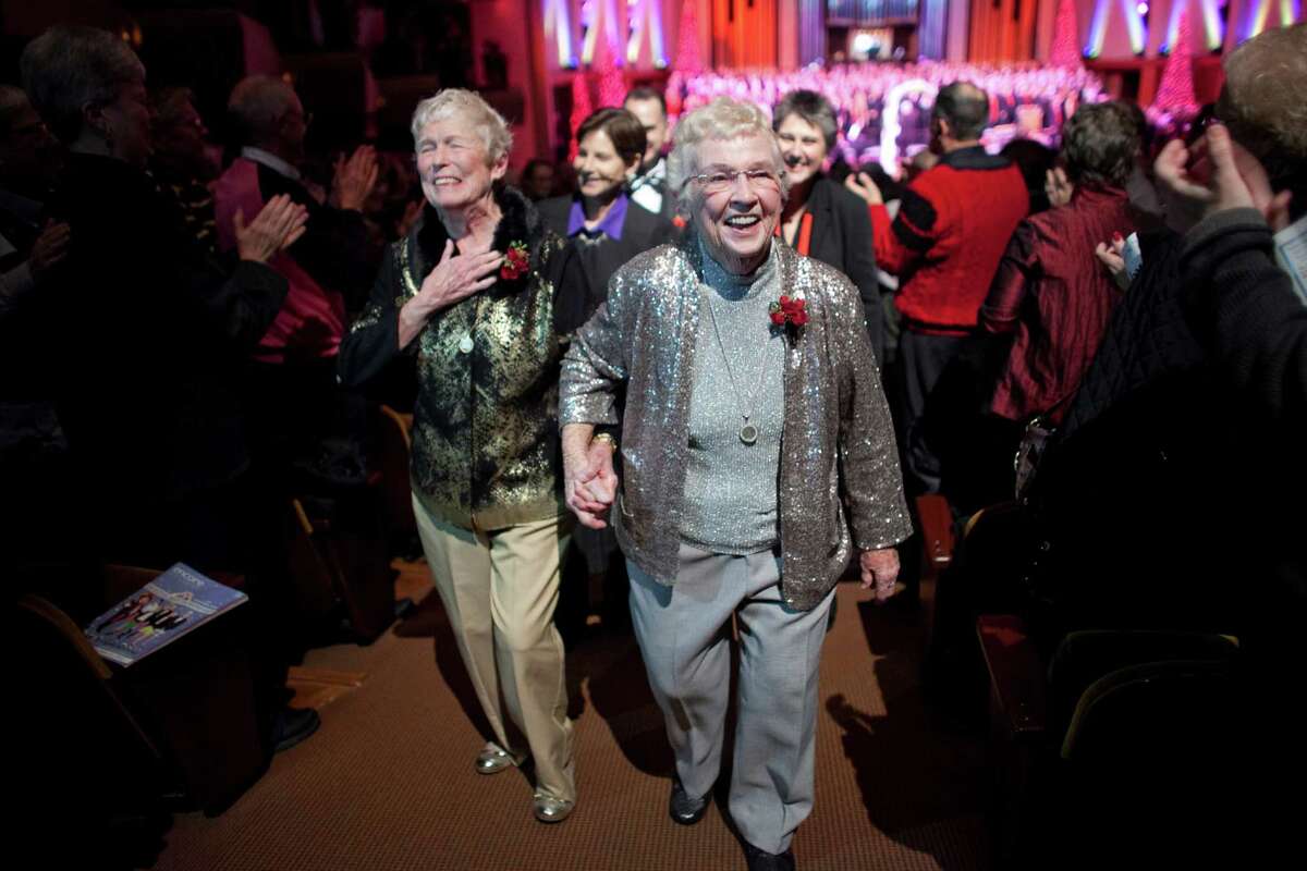 Jane Lightly, 77, and her wife Pete-e Petersen, 85, walk down the aisle after their wedding during a performance of the Seattle Men's Chorus on Sunday, December 9, 2012 at Benaroya Hall in Seattle. Lightly and Petersen have been a couple for 35 years. Sunday was the first day same-sex couple in Washington State could become legally married —something they have waited decades for.