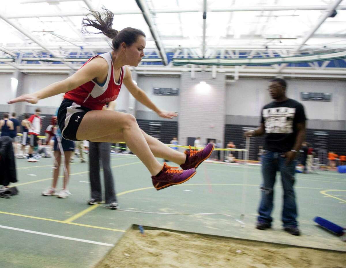 Fairfield Warde's Julia Palmieri does the long jump during the FCIAC boys and girls indoor track championships at the New Haven Athletic Center in New Haven, Conn., February 2, 2012.