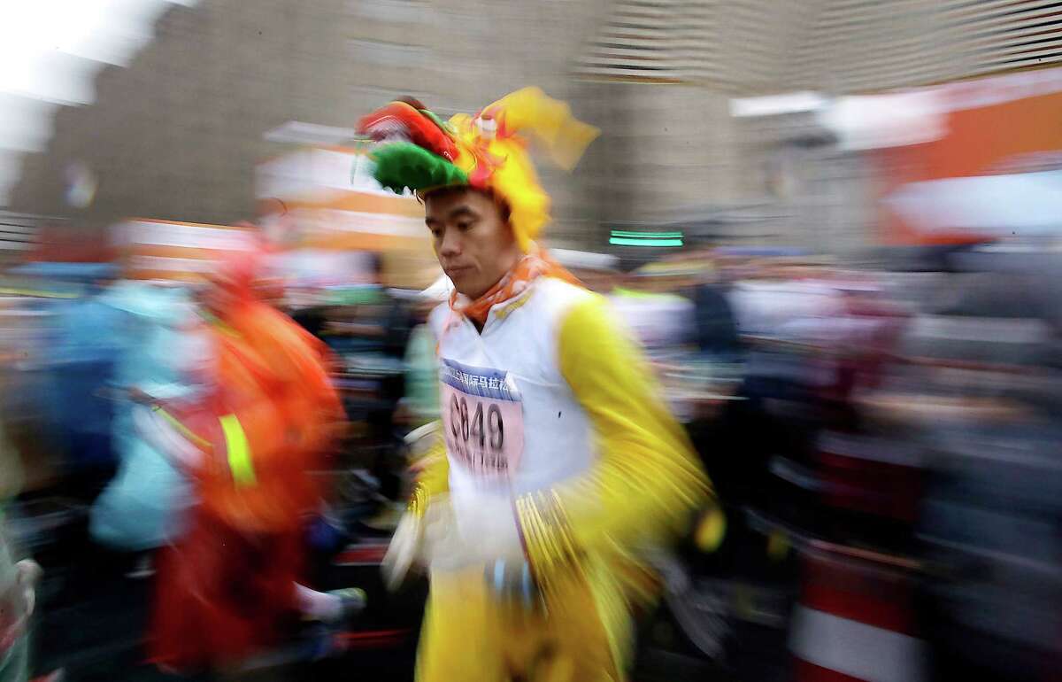 In most cultures, there are 12 zodiac signs. Here a runner in the outfit depicting dragon, which is this year's Chinese zodiac sign, gets off the start line during the Shanghai International Marathon in Shanghai, China on Sunday, Dec. 2, 2012. (AP Photo/Eugene Hoshiko)